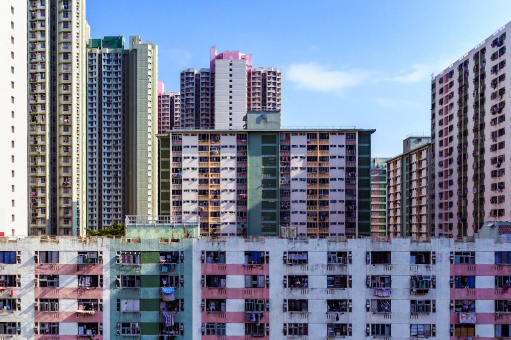 High-rise apartments and skyscrapers in Hong Kong's urban skyline.